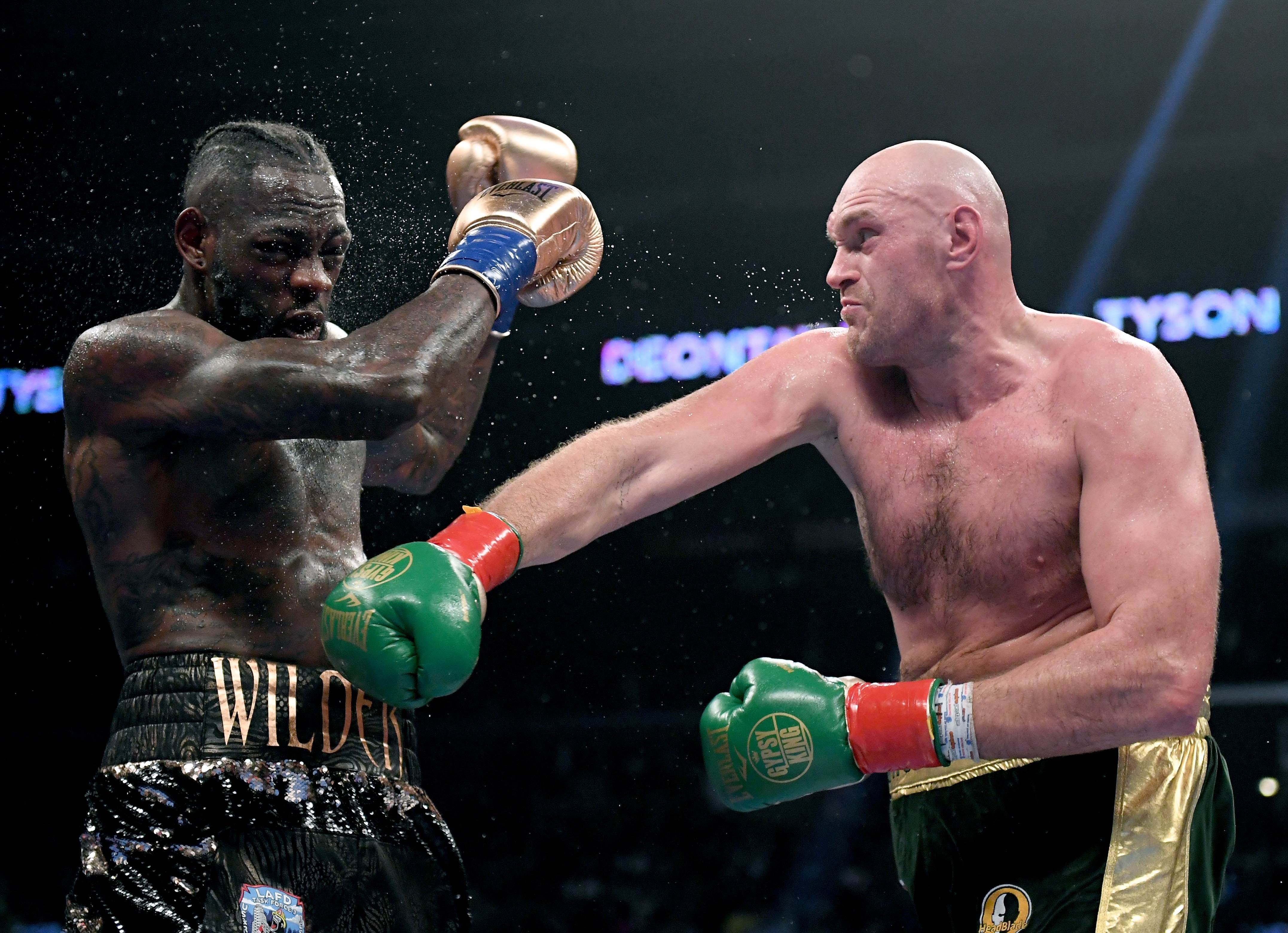 Tyson Fury throws a right hand against Deontay Wilder in the seventh round of their fight that ended in a controversial draw. Photo: AFP