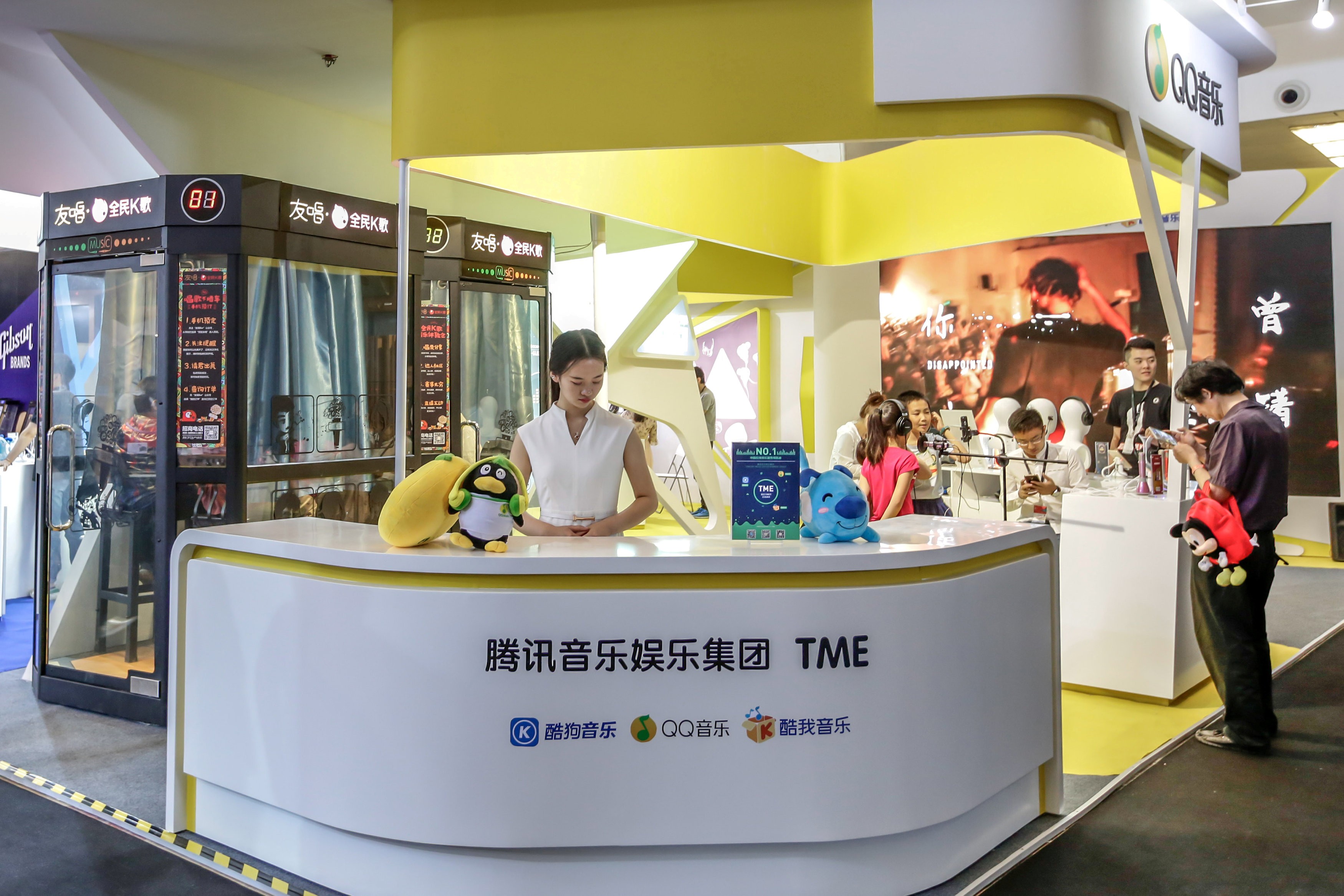Visitors at a booth of Tencent Music Entertainment in Beijing, China. Photo: Reuters