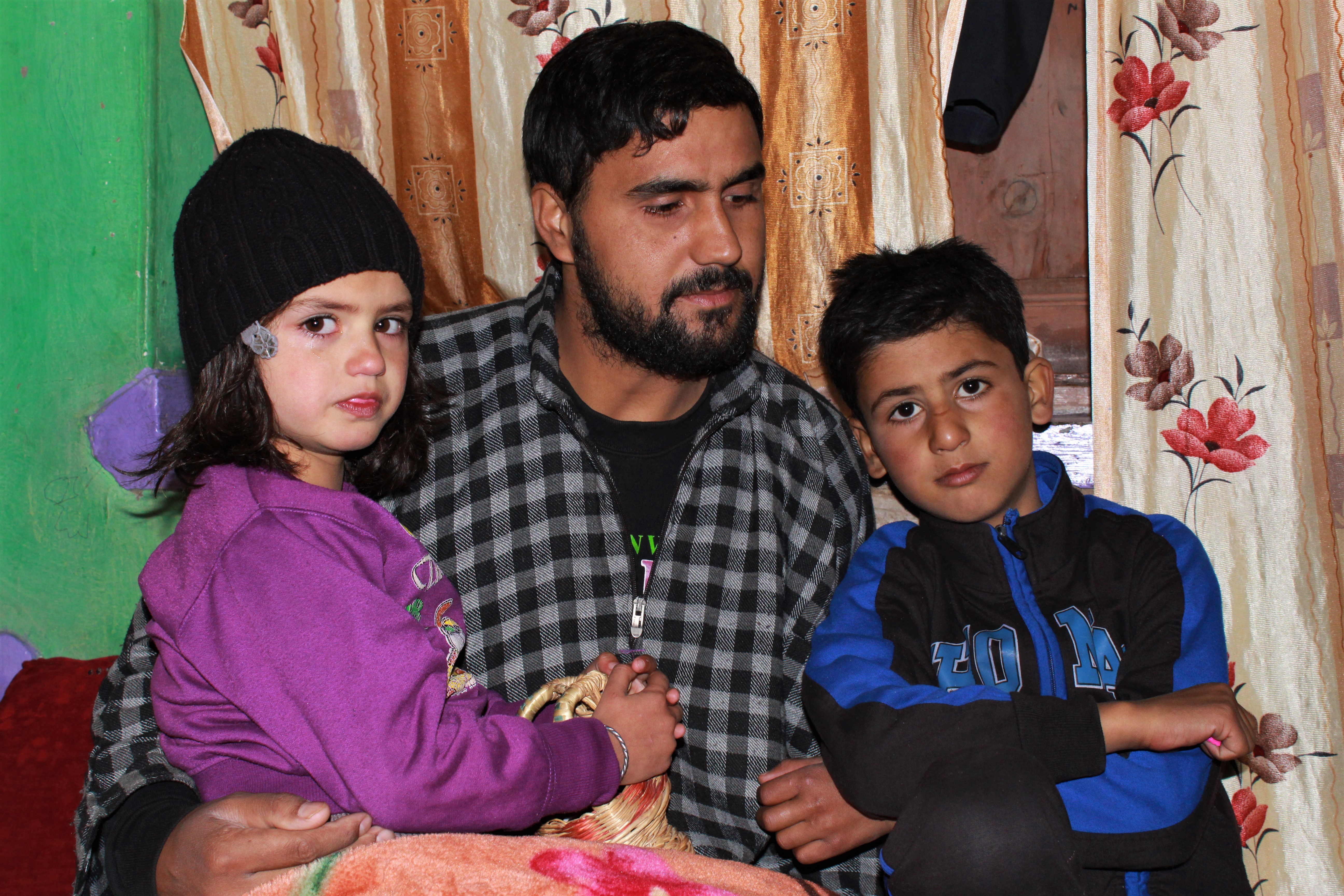 Khursheed Ahmad Sheikh with his son Misbah Khursheed, 7, and daughter Aalima Jan, 5. Photo: Saqib Mir