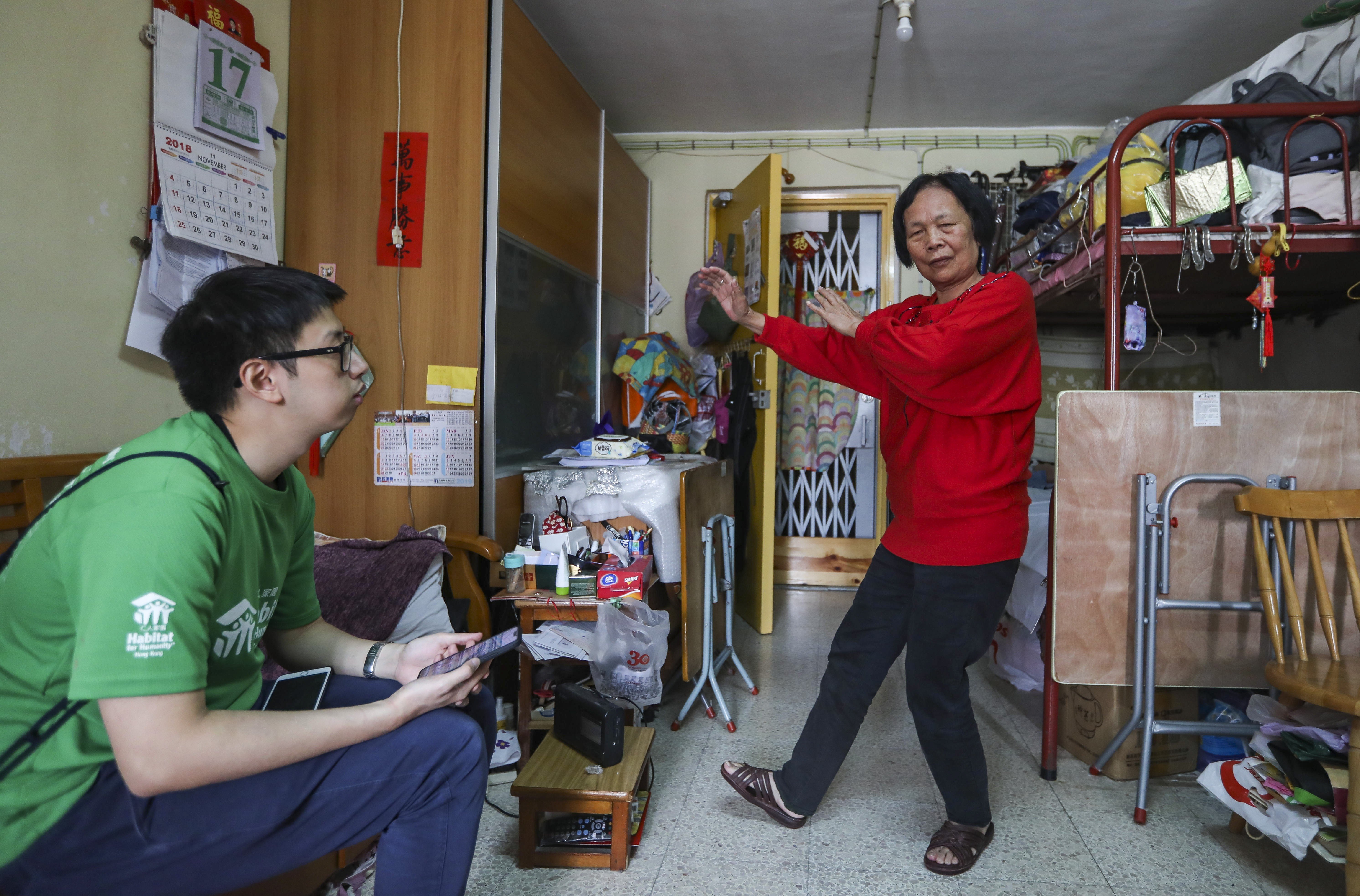 Ng Sau-fung (right), a beneficiary of Habitat for Humanity Hong Kong, shows off her tai chi moves in her home. Photo: Xiaomei Chen