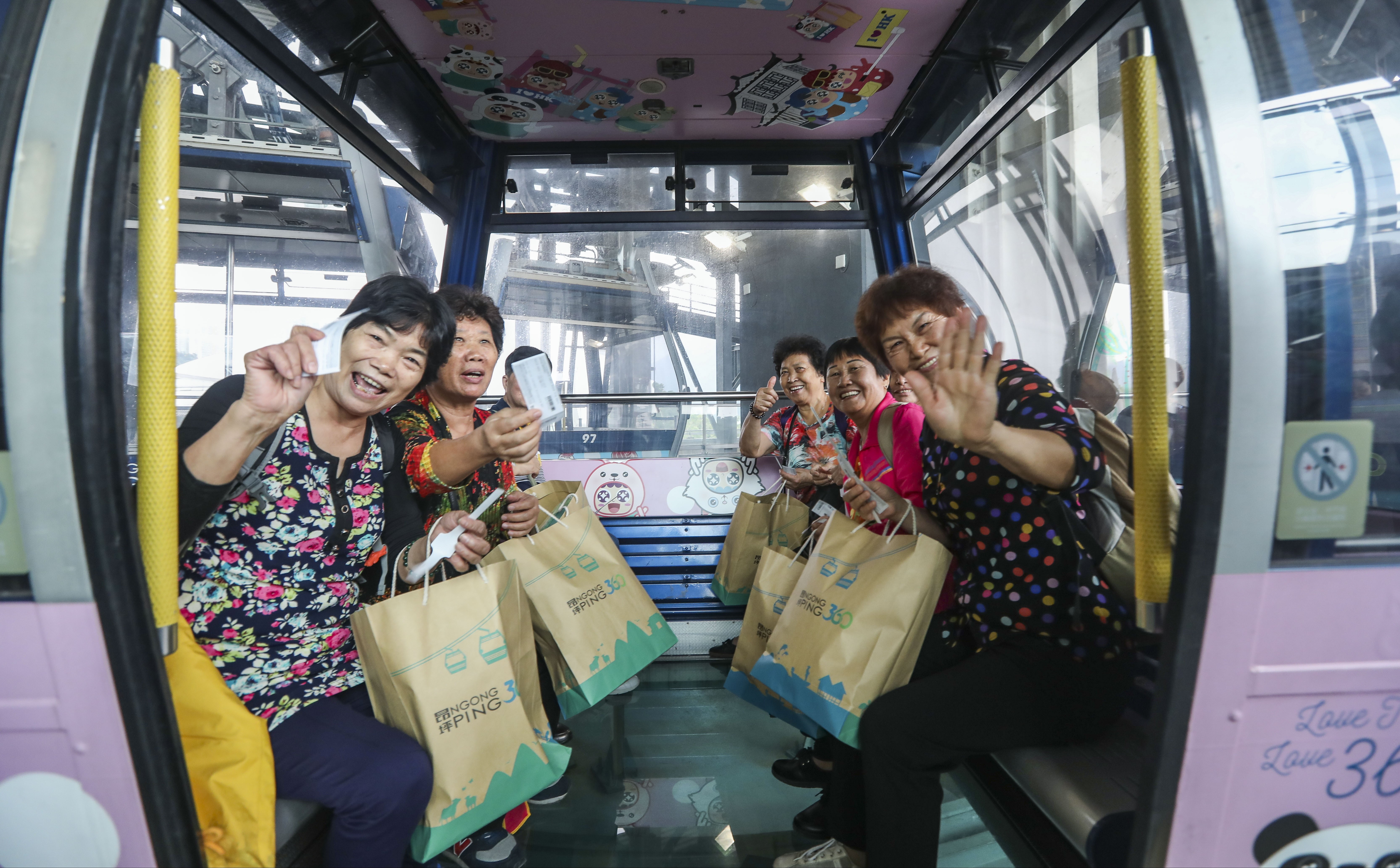 Visitors enjoy the Ngong Ping 360 cable car on Lantau Island. Photo: Xiaomei Chen