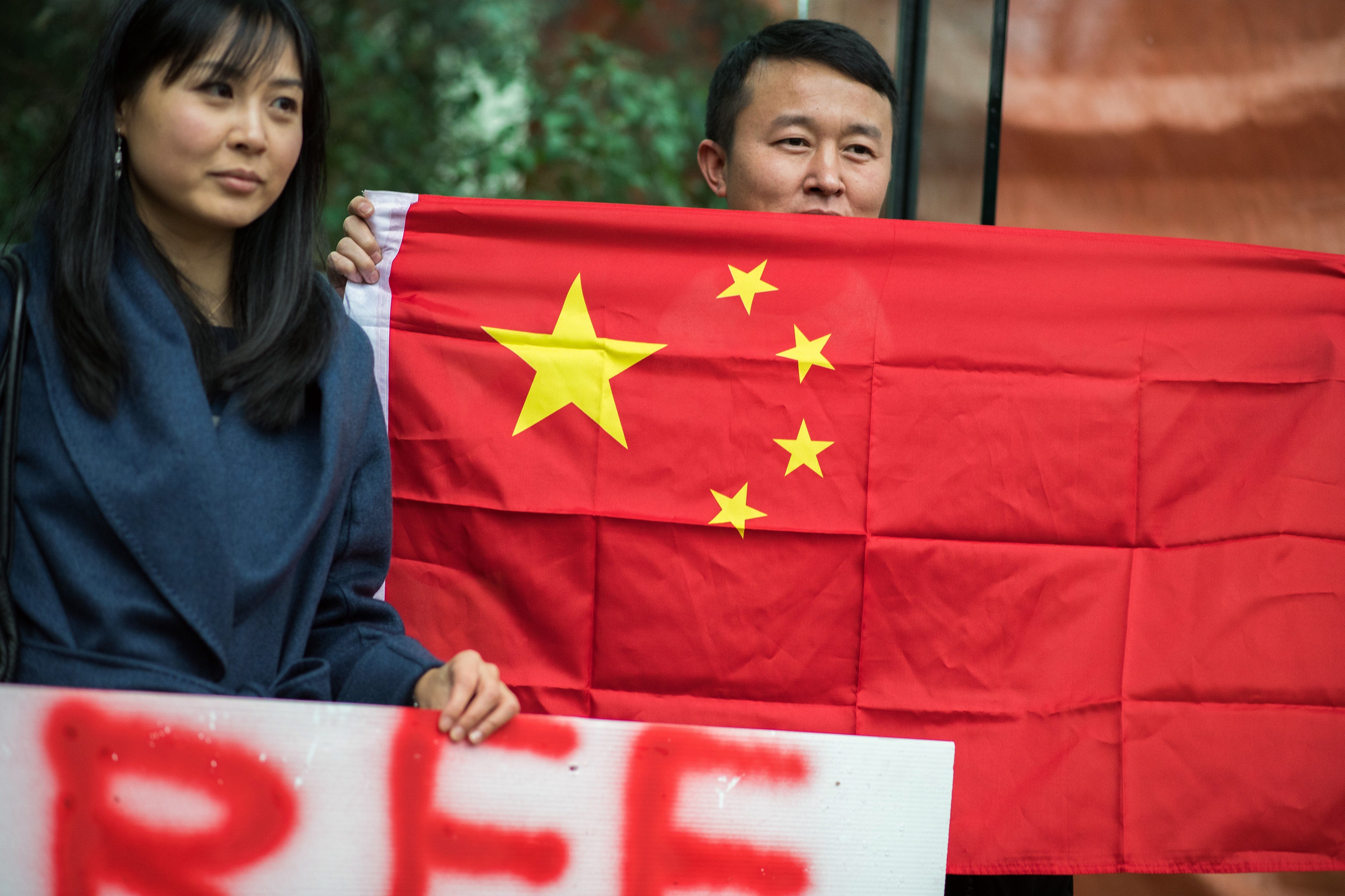 A man holds a Chinese flag in support of Huawei executive Meng Wanzhou outside a bail hearing in Vancouver on December 11. China has reacted to the incident by hitting back at Canada, instead of winning more friends around the world. Photo: Bloomberg