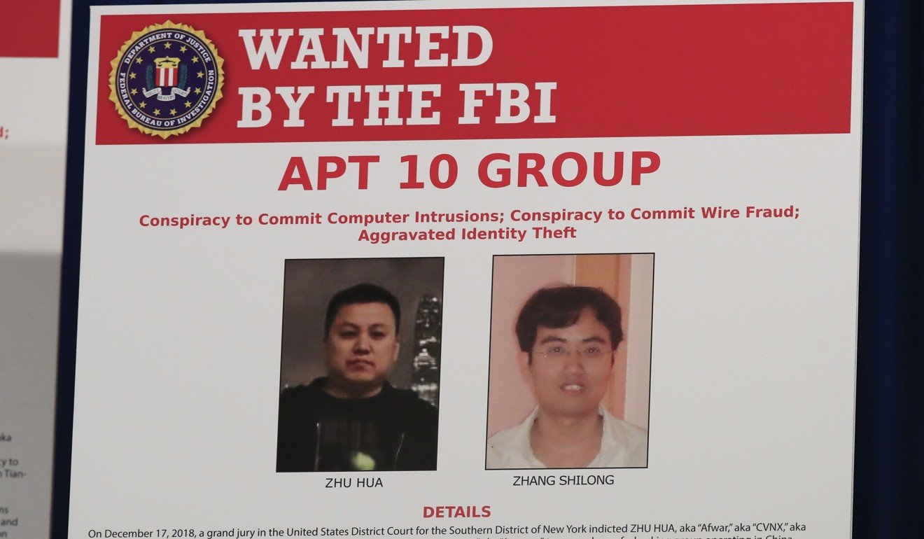 A poster displayed during a news conference at the Department of Justice in Washington, Thursday, Dec. 20, 2018, shows two Chinese citizens suspected to be with the group APT 10 carrying out an extensive hacking campaign to steal data from U.S. companies. The Justice Department is charging two Chinese citizens with carrying out an extensive hacking campaign to steal data from U.S. companies. An indictment was unsealed Thursday against Zhu Hua and Zhang Shillong. Court papers filed in Manhattan federal court allege the hackers were able to breach the computers of more than 45 entities in 12 states. (AP Photo/Manuel Balce Ceneta)