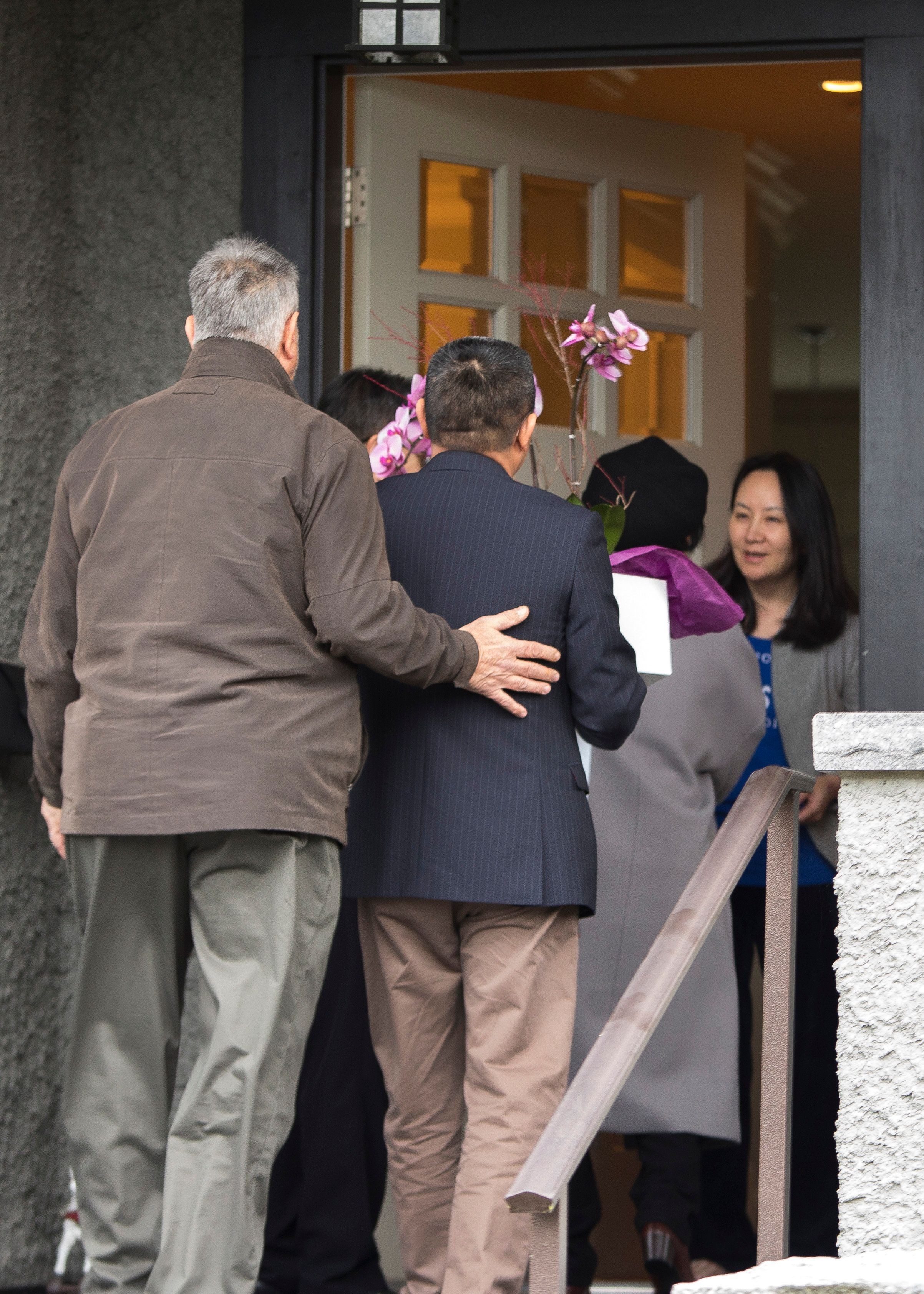 Huawei executive Meng Wanzhou answers the door after she is released on bail in Vancouver on December 12. Photo: AFP