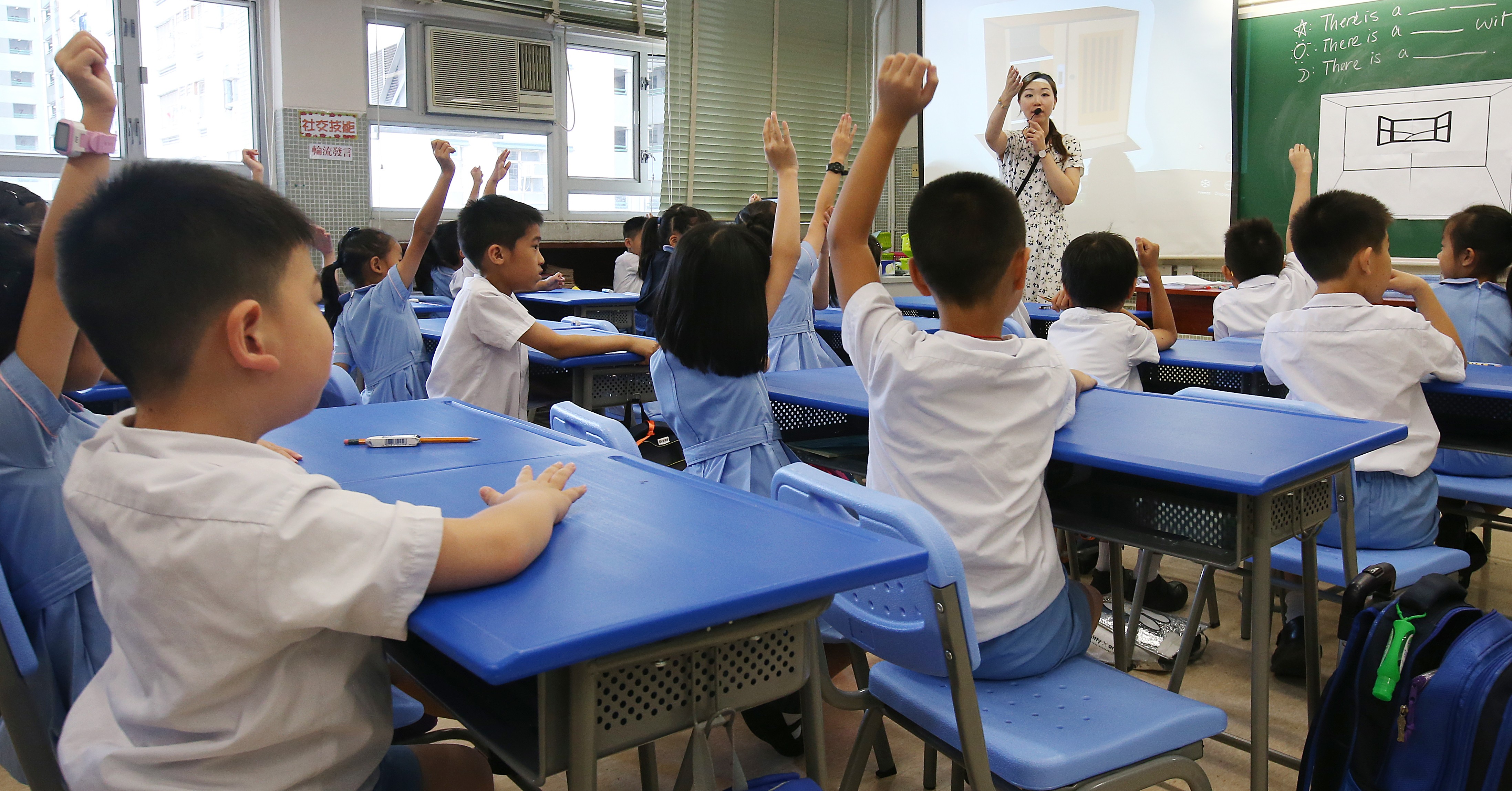 Teacher in a class at GCCITKD Cheong Wong Wai Primary School in Sha Tin. More than 10 per cent of the 630 pupils in the school have special educational needs ranging from autism to attention deficit hyperactivity disorder. David Wong