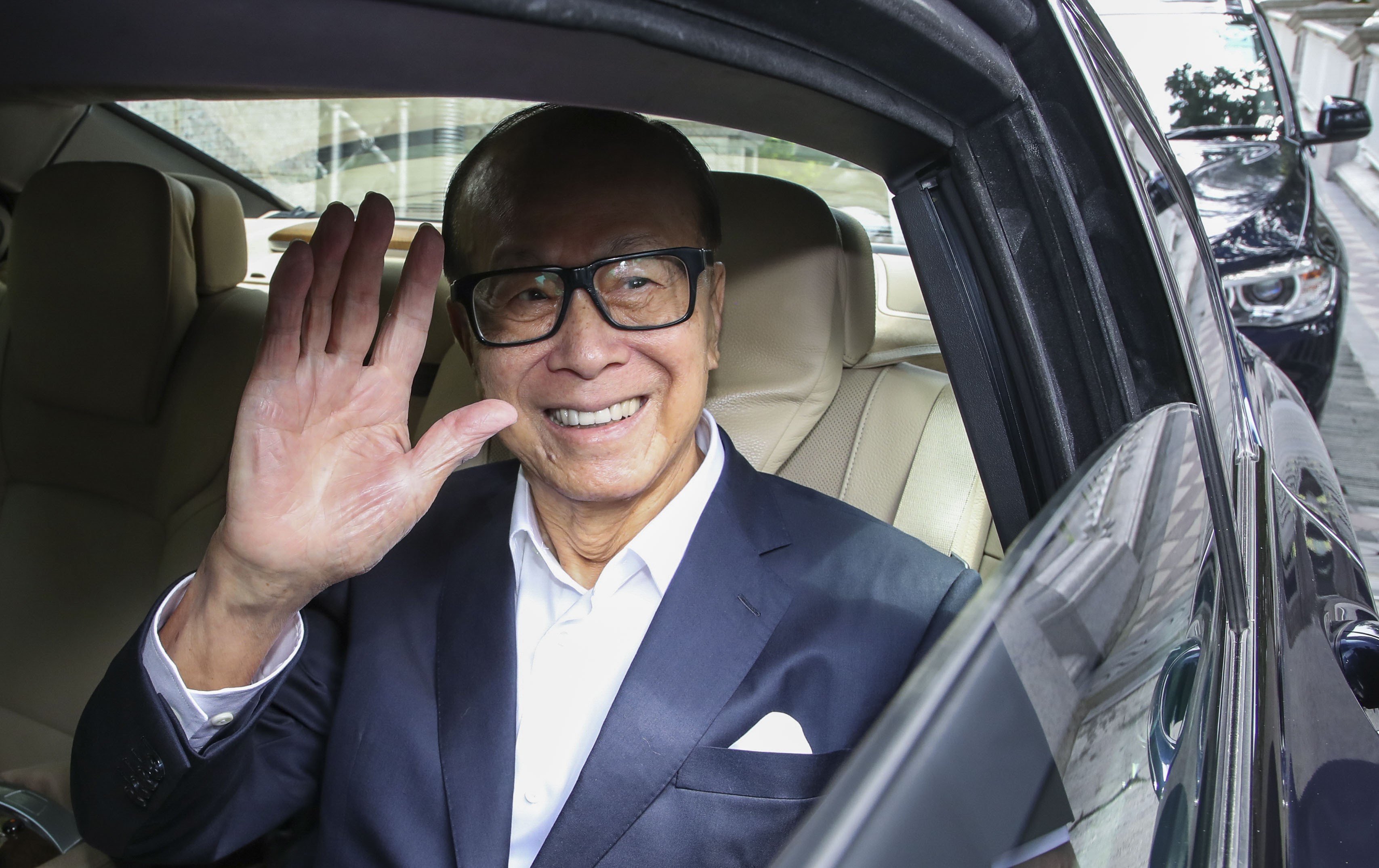Li Ka-shing leaves his home in Deep Water Bay. The tycoon officially retired last year and relinquished managerial control of CK Hutchison, a conglomerate that had its roots in plastic flowers 50 years ago. Photo: Edward Wong