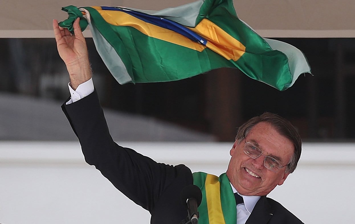 Jair Bolsonaro, Brazil’s new president, waves the national flag as he delivers a speech during his inauguration ceremony in Brasilia on Tuesday. Photo: EPA-EFE