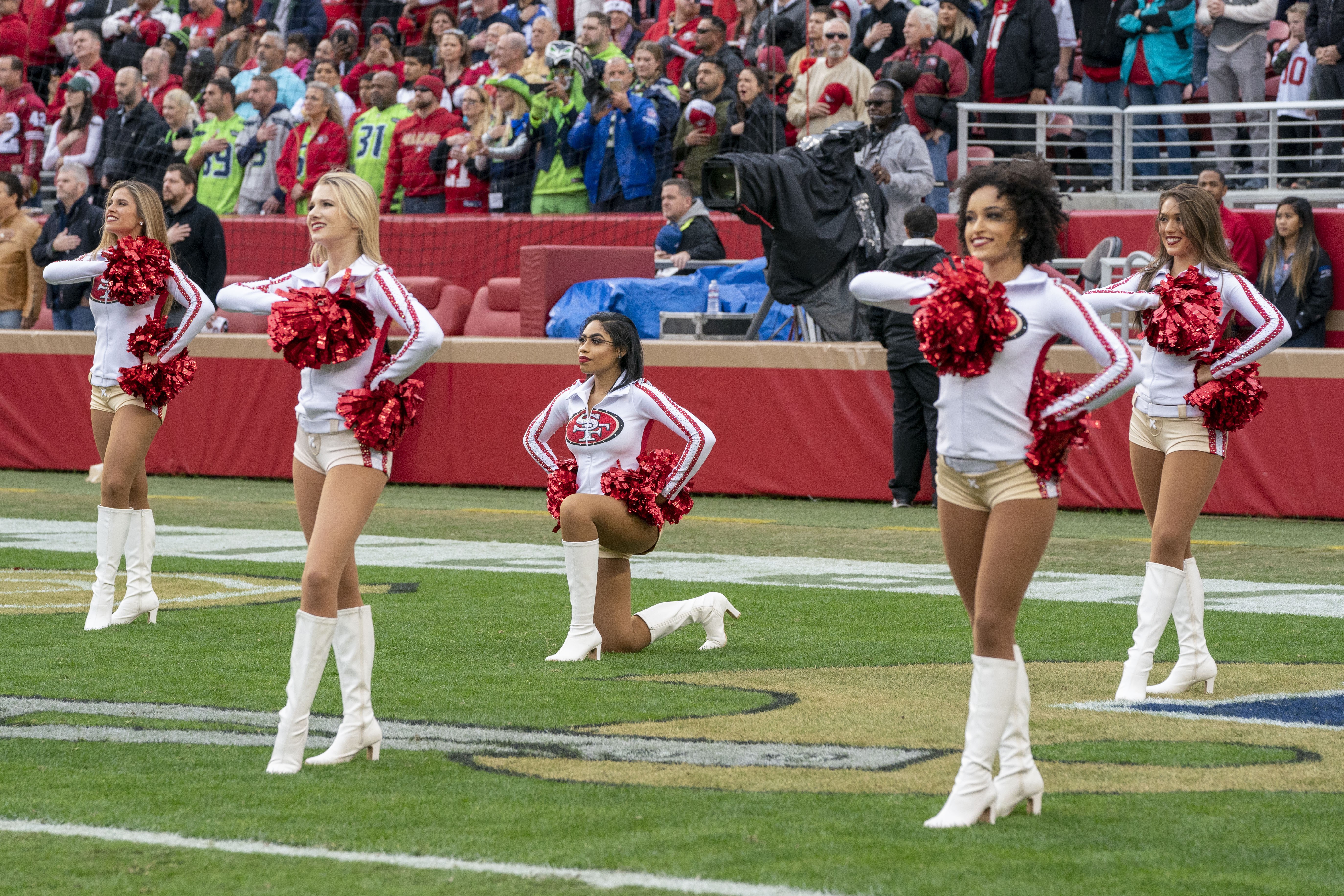 San Francisco 49ers cheerleader takes a knee during national anthem