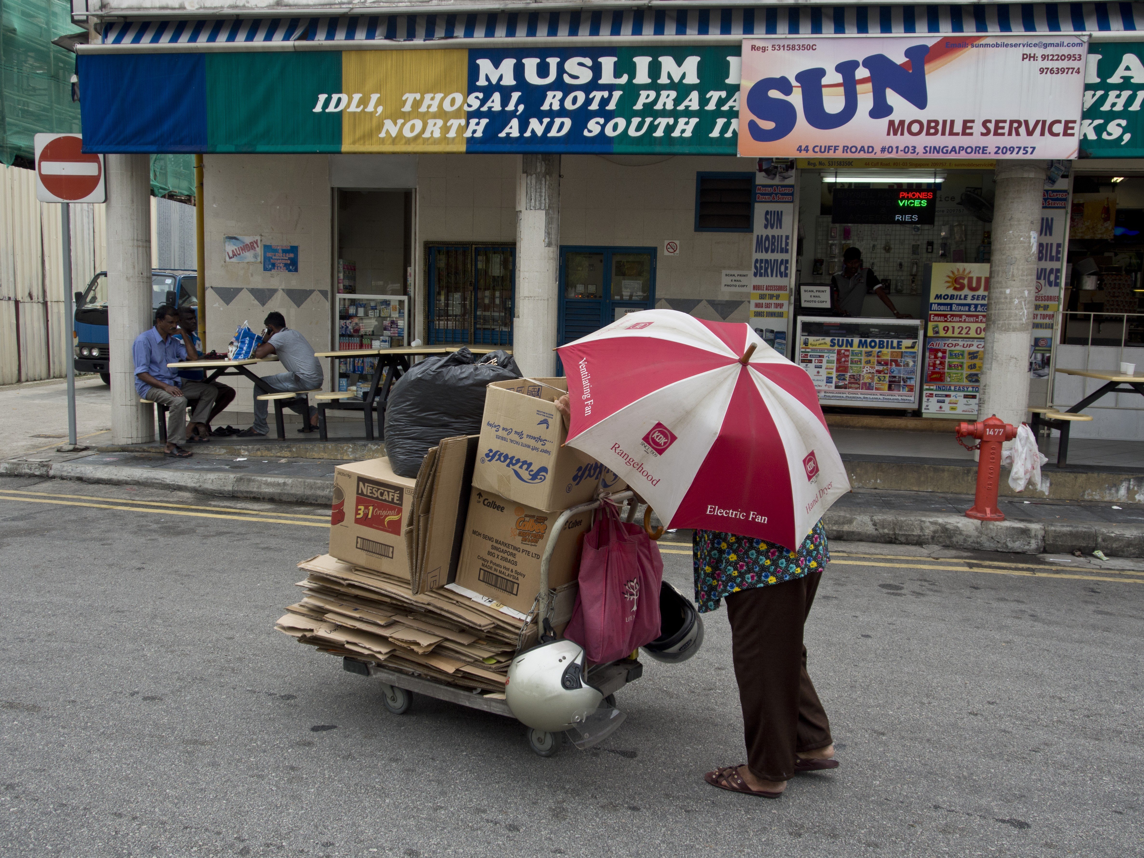 A man collects cardboard to earn money in Singapore. Care’s campaign ‘No Singaporeans Left Behind’ is an effort to open up a conversation on poverty in the Lion City. Photo: Julio Etchart