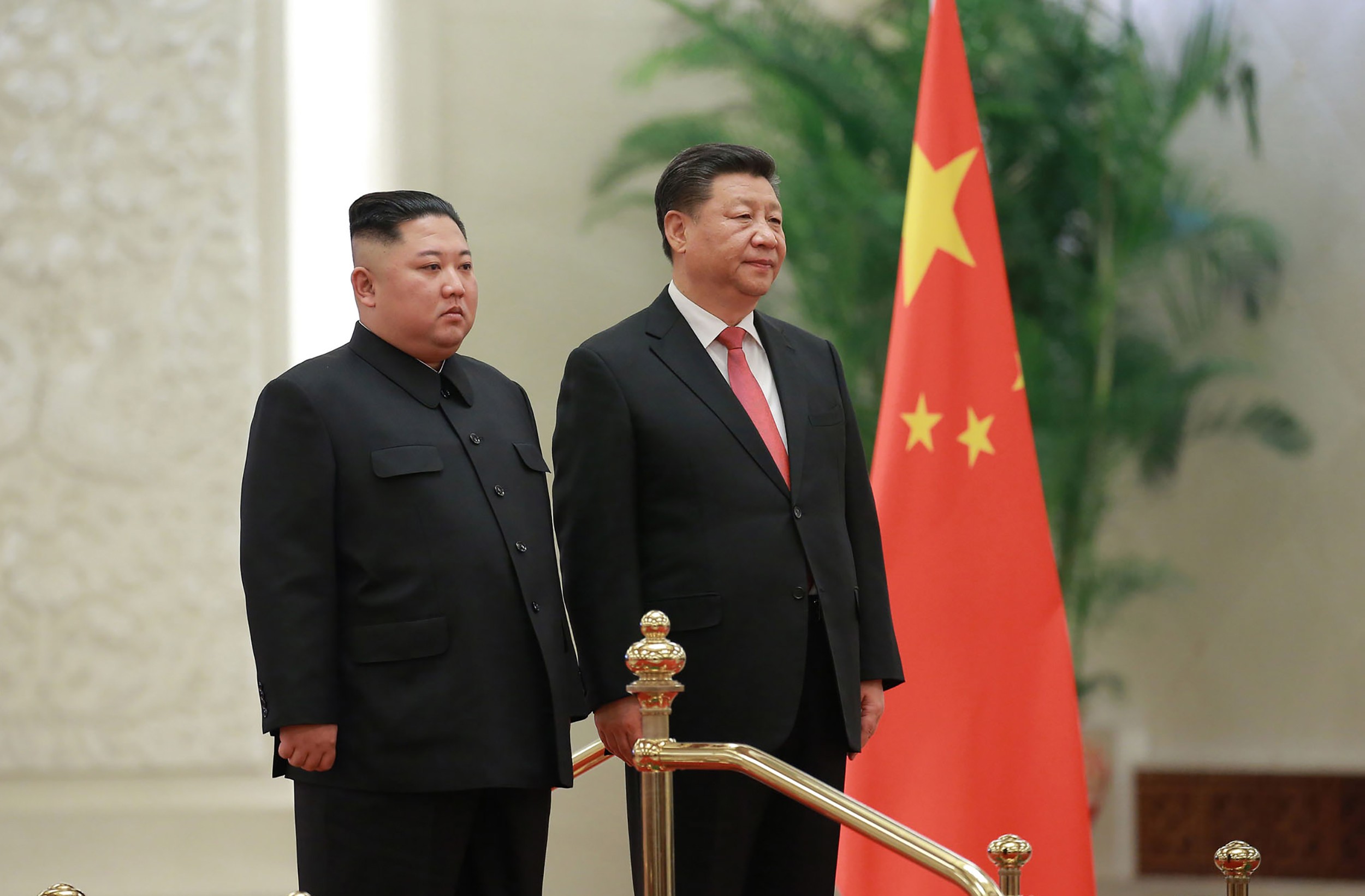 North Korea's leader Kim Jong-un stands alongside China's President Xi Jinping during a welcome ceremony at the Great Hall of the People in Beijing on January 8. Photo: KCNA via KNS/AFP