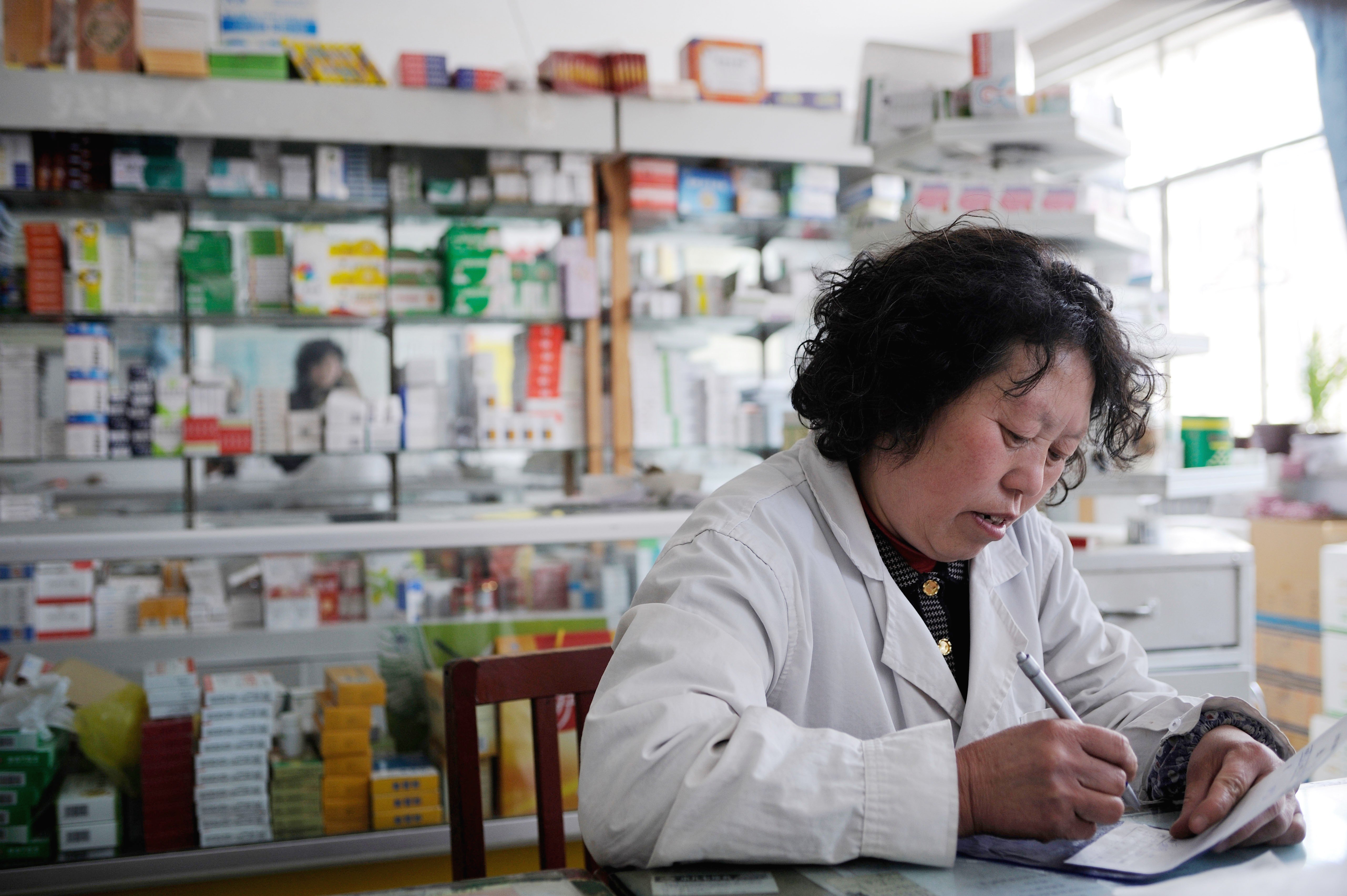 Beijing has moved to cut prices of drugs and improve their efficacy and safety. Here a woman works at the pharmacy of a state-owned hospital in a town in Hebei province, China, in this photo taken in 2008.