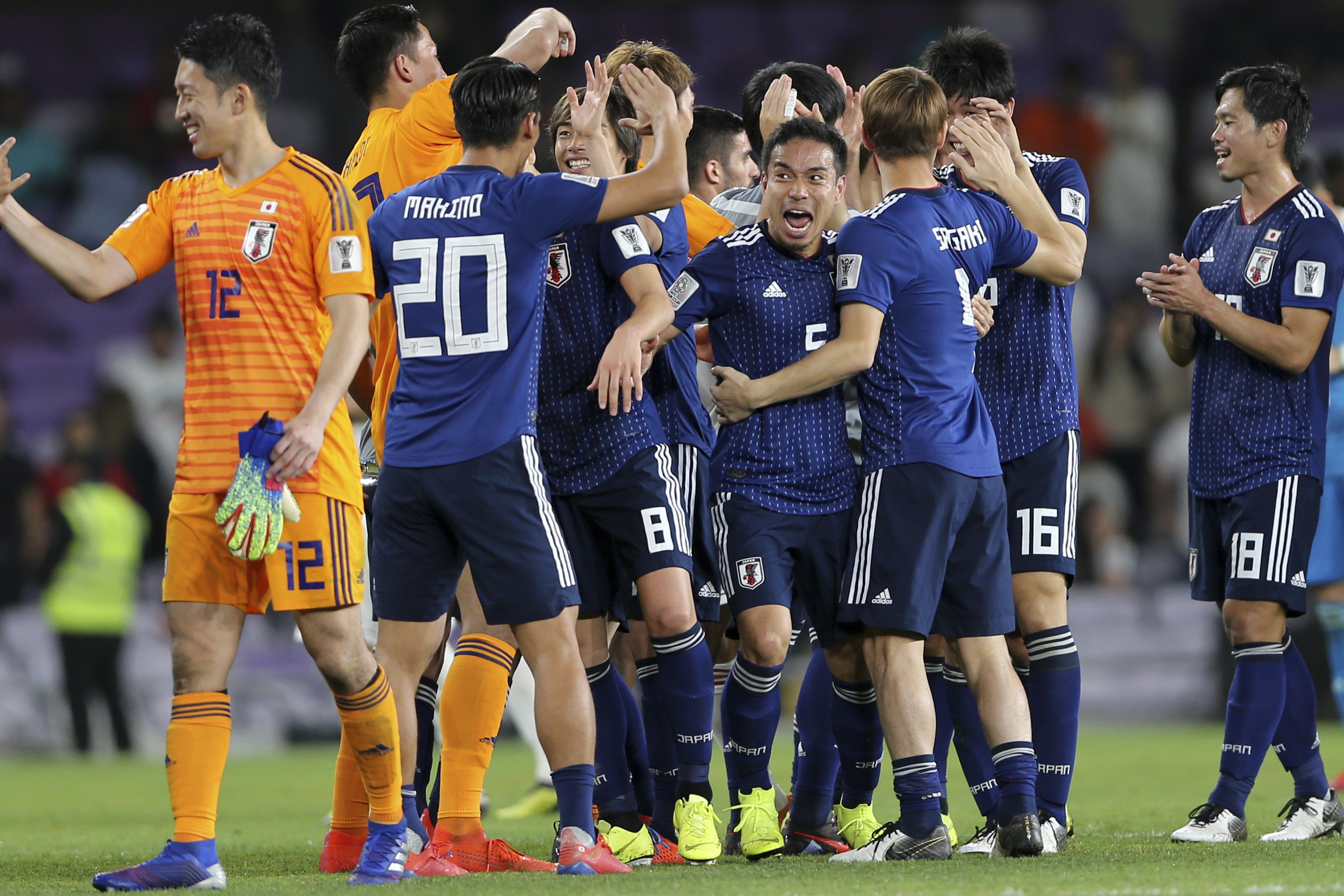 Japan defender Yuto Nagatomo celebrates with teammates after the AFC Asian Cup semi-final win over Iran. Photo: AP