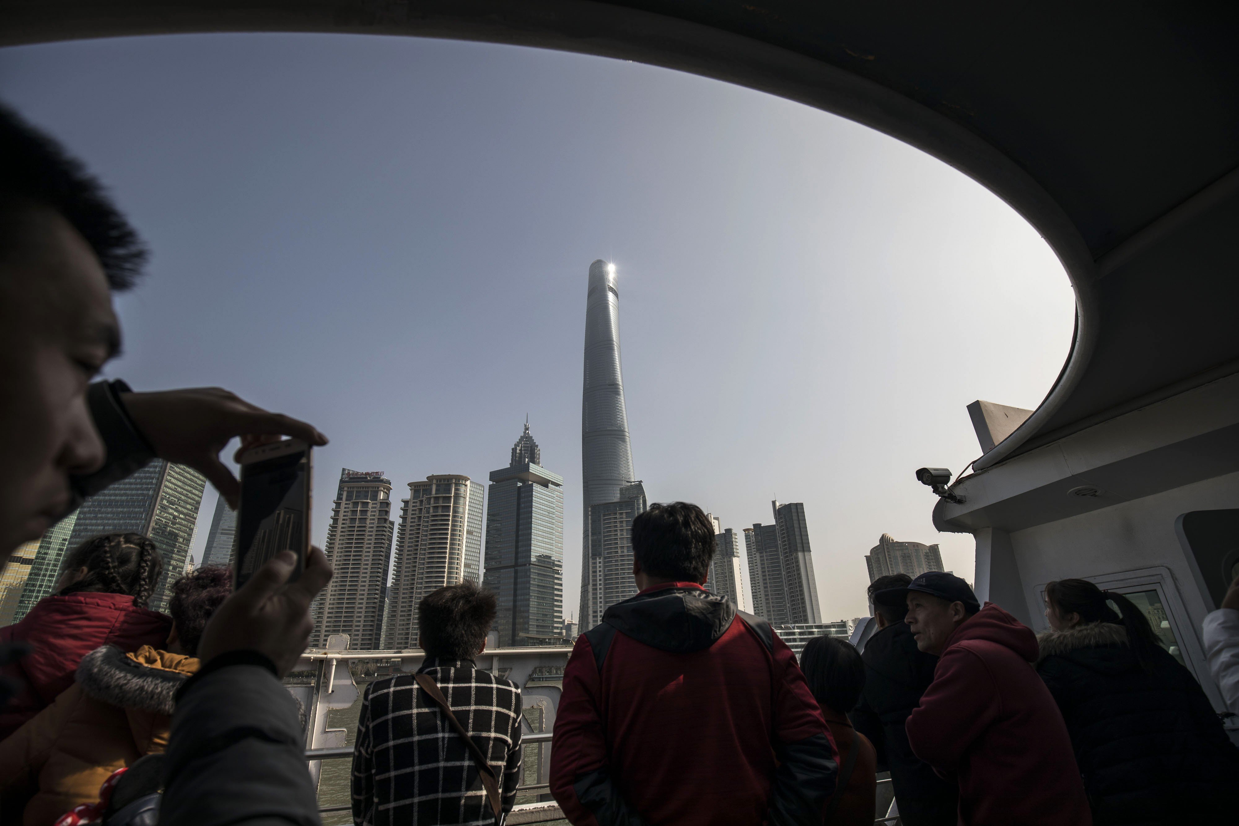 Tourists take a ferry across the Huangpu River in front of the Lujiazui Financial District in Shanghai. Finance is one sector of the Chinese economy that experts say needs to be opened up. Photo: Bloomberg