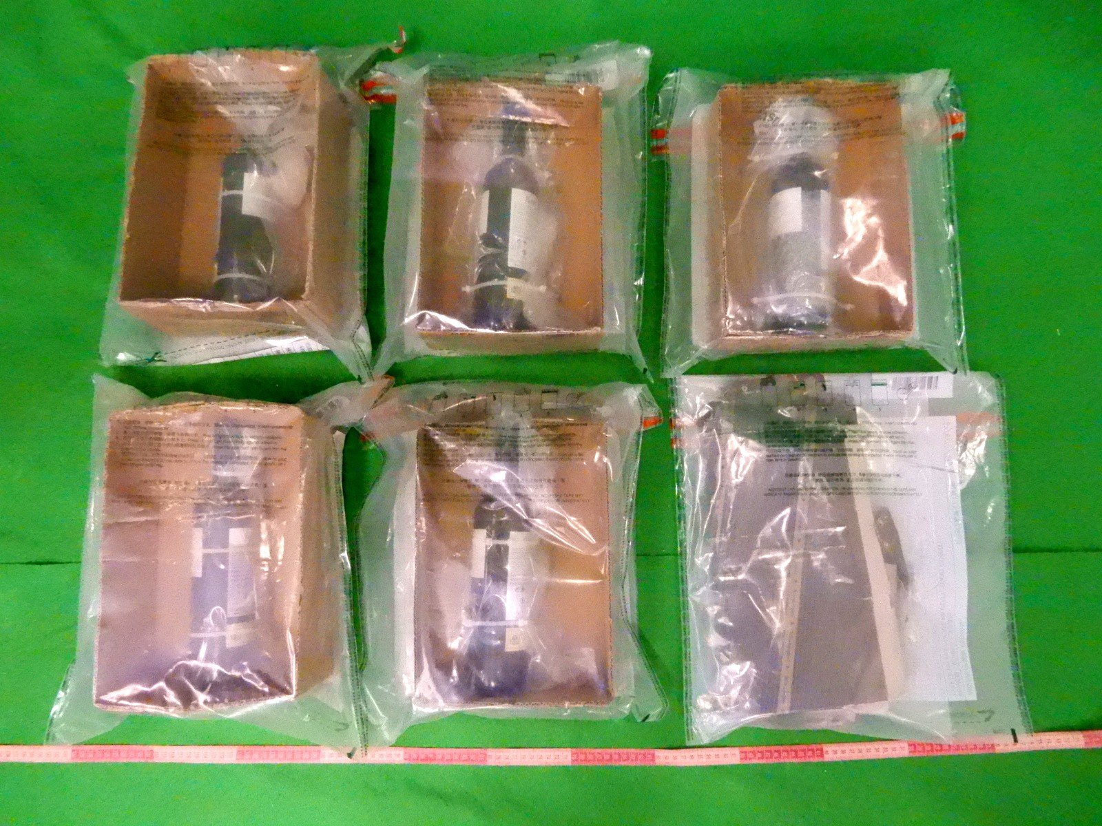 Customs officers seized wine bottles at Hong Kong International Airport containing four kilograms of suspected liquid cocaine with an estimated market value of about HK$4.8 million (US$615,000) during a comprehensive smuggling investigation. Photo: Handout