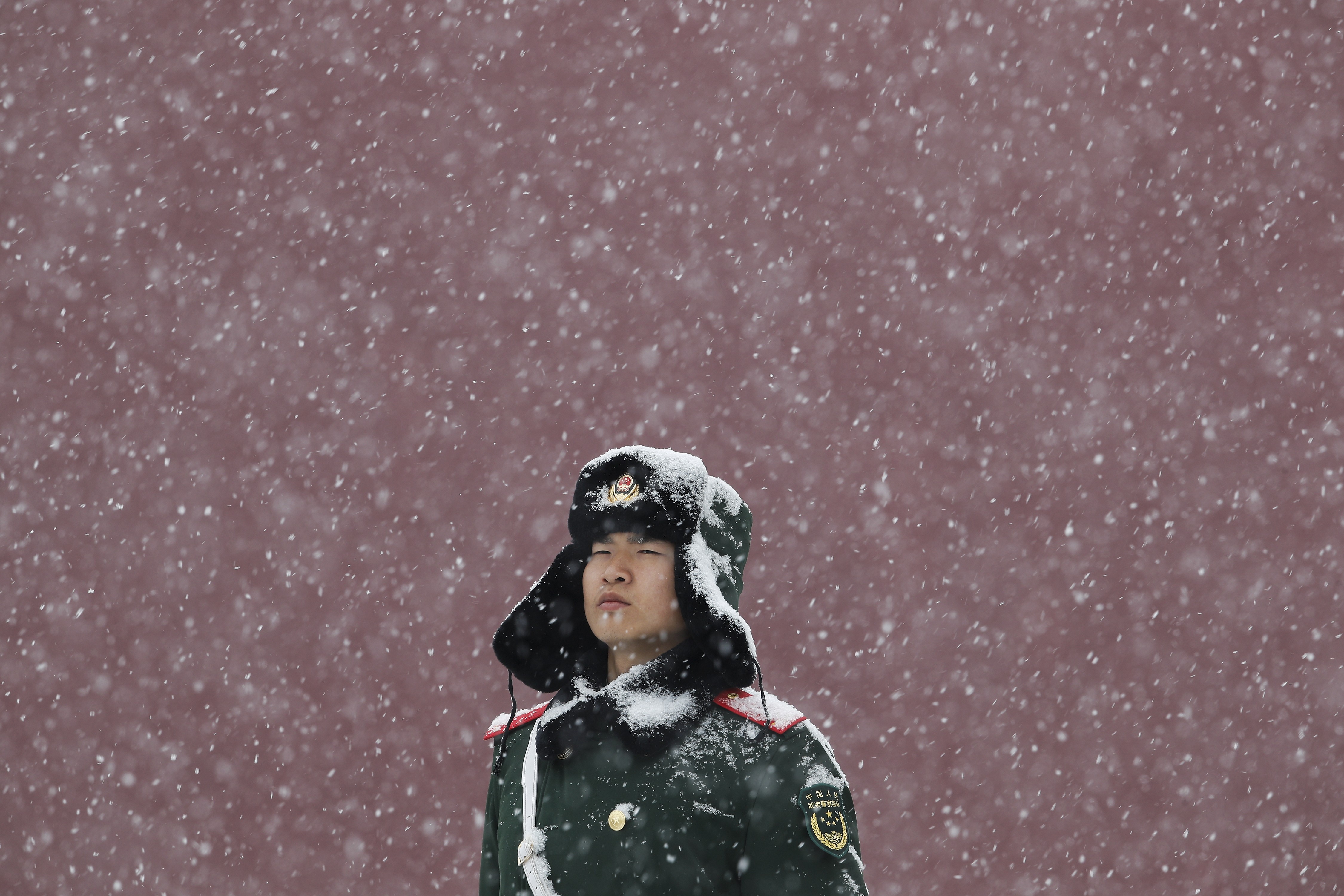 A paramilitary police officer stands guard outside Tiananmen as snow falls in Beijing on February 12. The Chinese civilisation has gone through many ups and downs in its history and learned many bitter lessons. Photo: AP