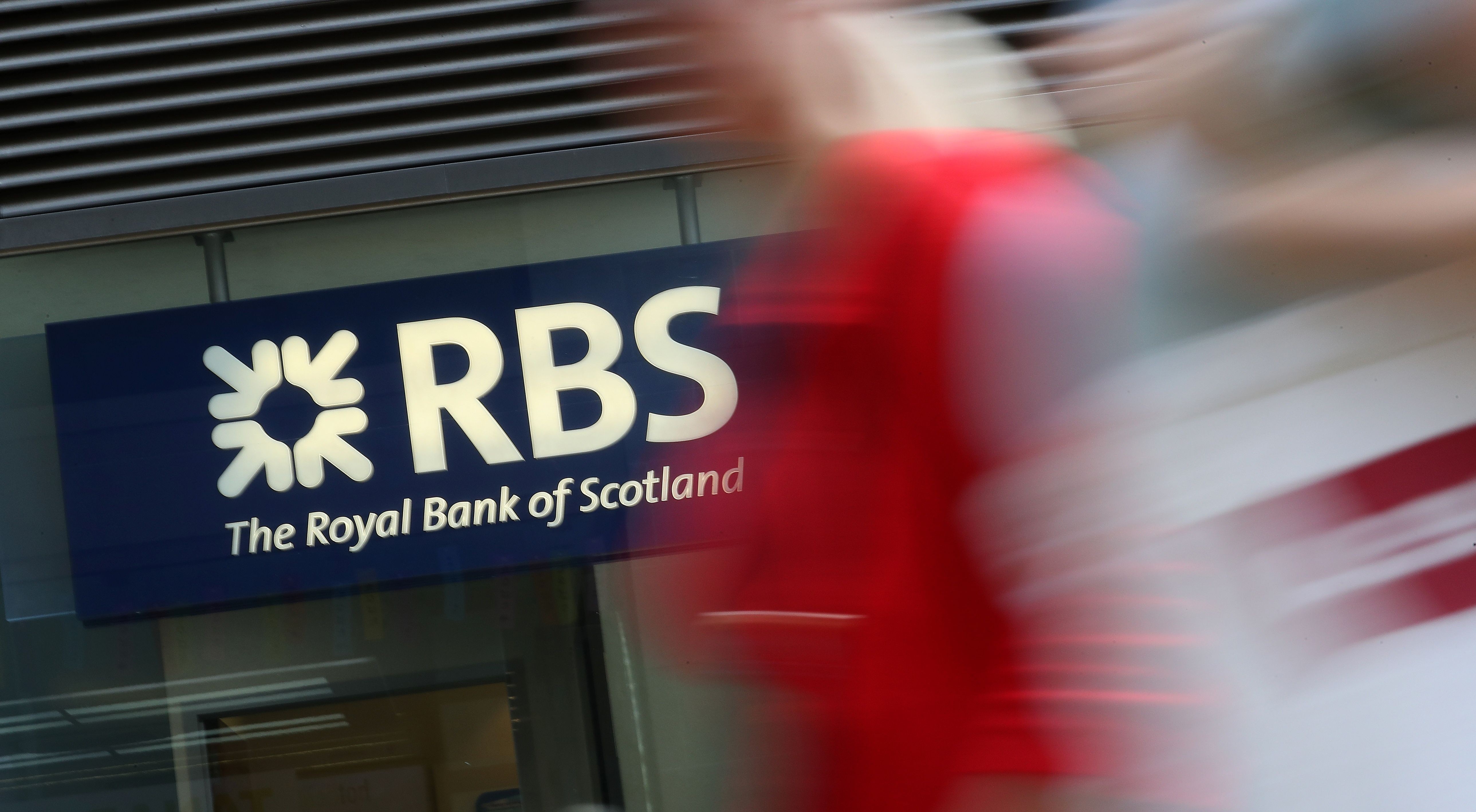 Pedestrians pass a branch of Royal Bank of Scotland. Photo: AFP
