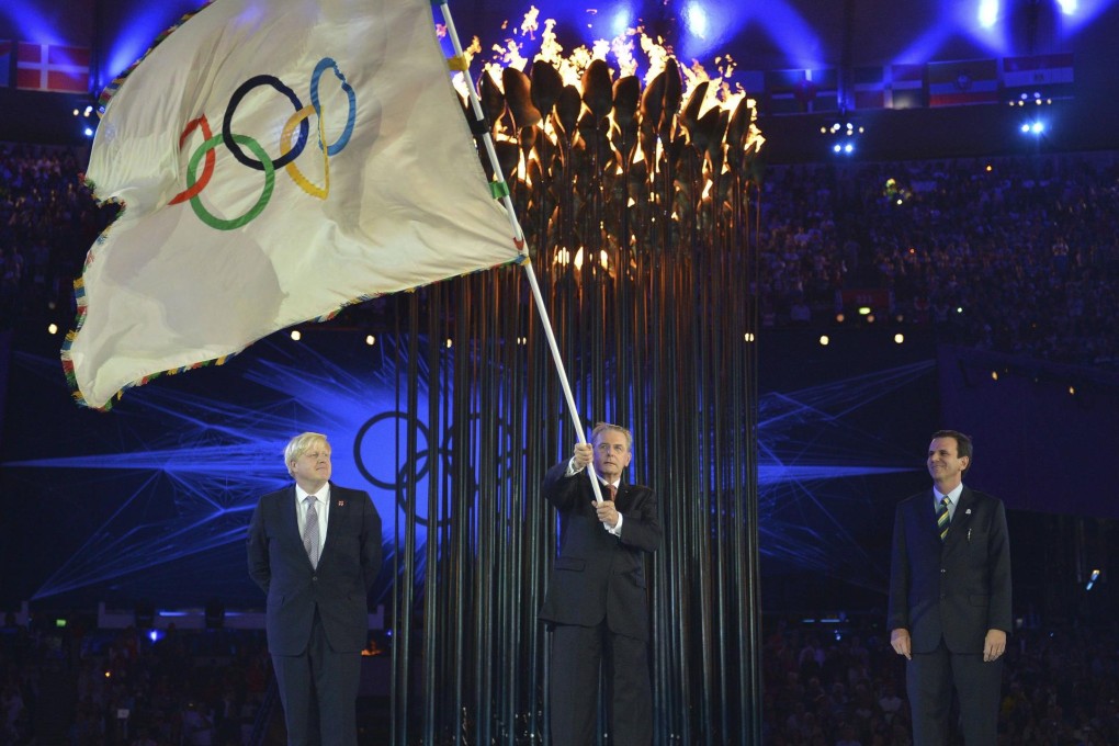 IOC president Jacques Rogge holds the Olympic flag after receiving it from London mayor Boris Johnson at the end of a 'glorious' Games.Photo: Reuters