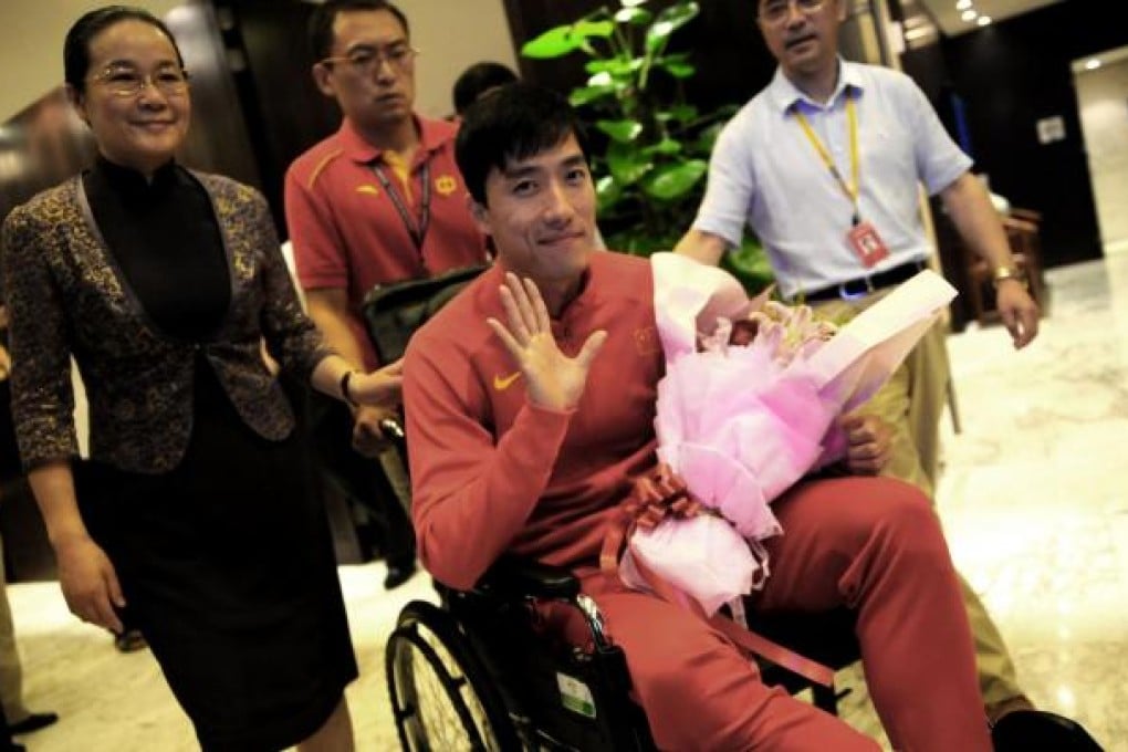 Liu Xiang arrives yesterday after surgery in London.Photo: AFP