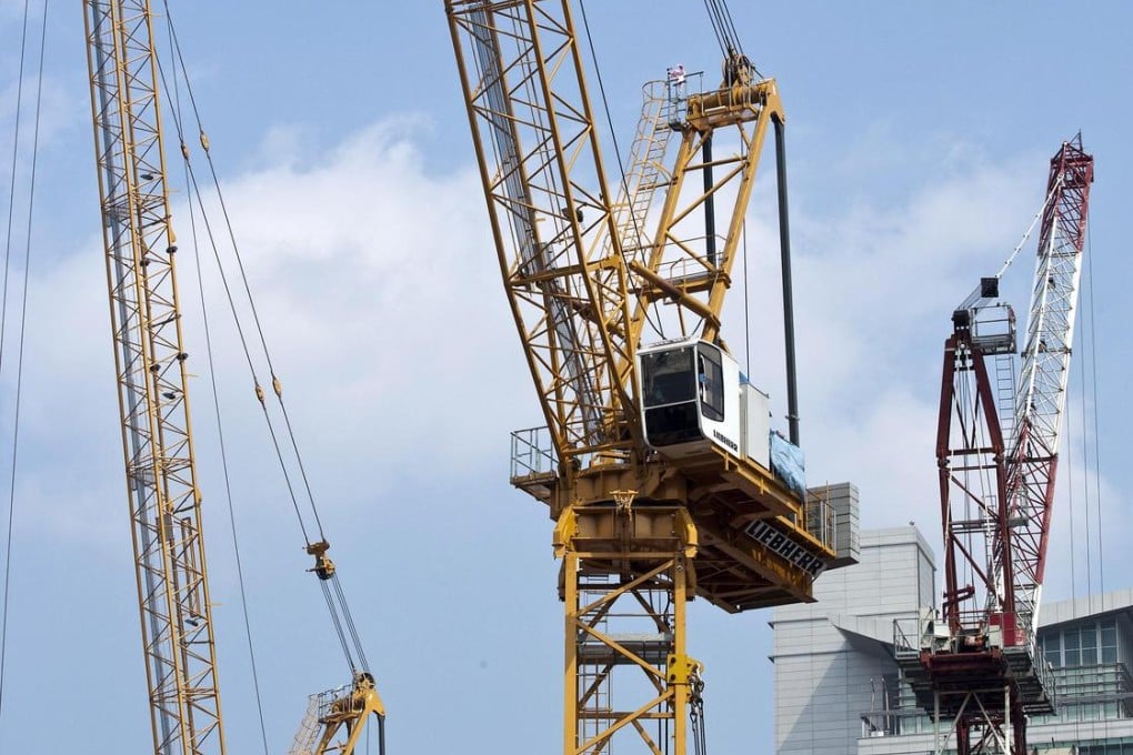 Cranes operate on the construction site of a new development that will feature shops, restaurants, hotels and residential properties as Singapore's real estate market continues to strengthen.Photo: Bloomberg