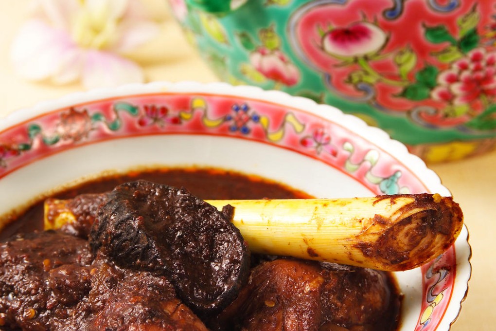 True Blue signature dish ayam buah keluak, a chicken stew with a black sauce made from the nuts of the kepayang tree.