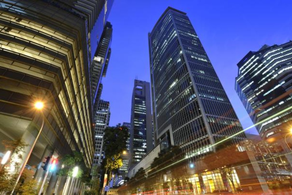 Singapore is thriving, thanks to its open economy, buoyant capital markets and active stock exchange, based in the SGX Centre (centre).Photo: Bloomberg