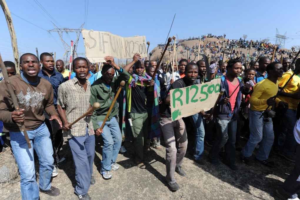Strikers rally yesterday near the Marikana mine.Photo: AFP