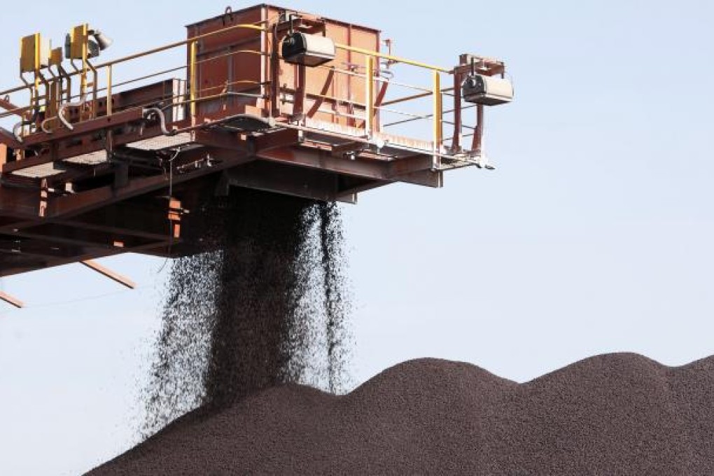 A conveyer belt dumps iron ore into a pile at an iron ore transfer and storage center operated by the Shanghai International Port Group in Shanghai, China, on Tuesday, Jan. 26, 2010. Bloomberg/Qilai Shen