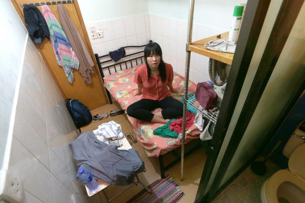 Joanna Chiu sits on the bed in her tiny room, her clothes and mattress soaked and the room musty after her air conditioner leaked overnight. Below, the stairway of the building in Sham Shui Po.Photos: David Wong