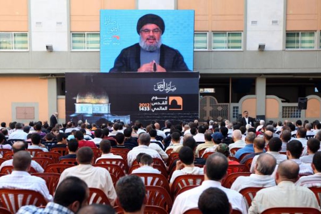 Hezbollah leader Hassan Nasrallah speaks via a video link in Lebanon, warning Israel of retaliation for any aggression.Photo: AP