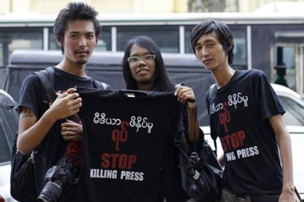 Journalists pose with a shirt during a protest along the streets of Yangon, August 4, 2012. REUTERS/Soe Zeya Tun