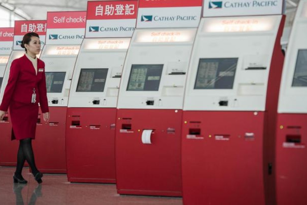 Self check-in booths are part of Cathay's services; the airline's image could take a hit if it starts charging for checking in luggage.Photo: AFP
