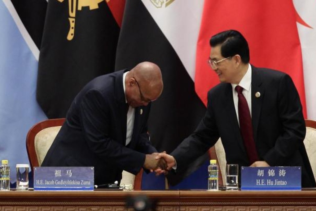 Chinese President Hu Jintao (right) greets South African President Jacob Zuma. Hu offered US$20 billion in loans to Africa. Photo: Reuters