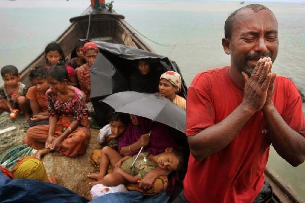 This man, with fellow Rohingya Muslim refugees, pleads for help after their boat was intercepted by Bangladeshi border guards. Photo: AP