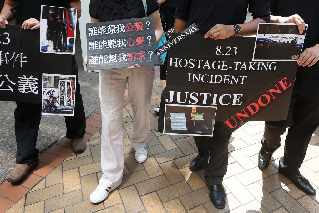 Survivors and relatives of the victims of the Manila hostage crisis march to the Philippine consulate in Admiralty yesterday to demand justice. Photo: Sam Tsang