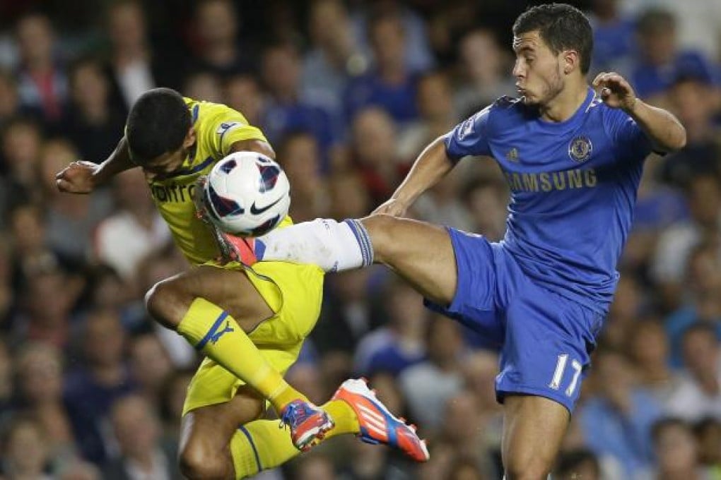 Chelsea's new signing Eden Hazard (right) competes for the ball with Reading's Jobi McAnuff in their Premiership clash in London. Photo: AP