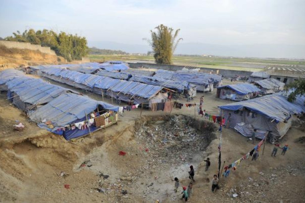 Refugees from Myanmar's Bhamo city live in tents at a rescue camp in the Chinese southwestern border city of Ruili, Yunnan province in this February 9, 2012 file photograph. REUTERS