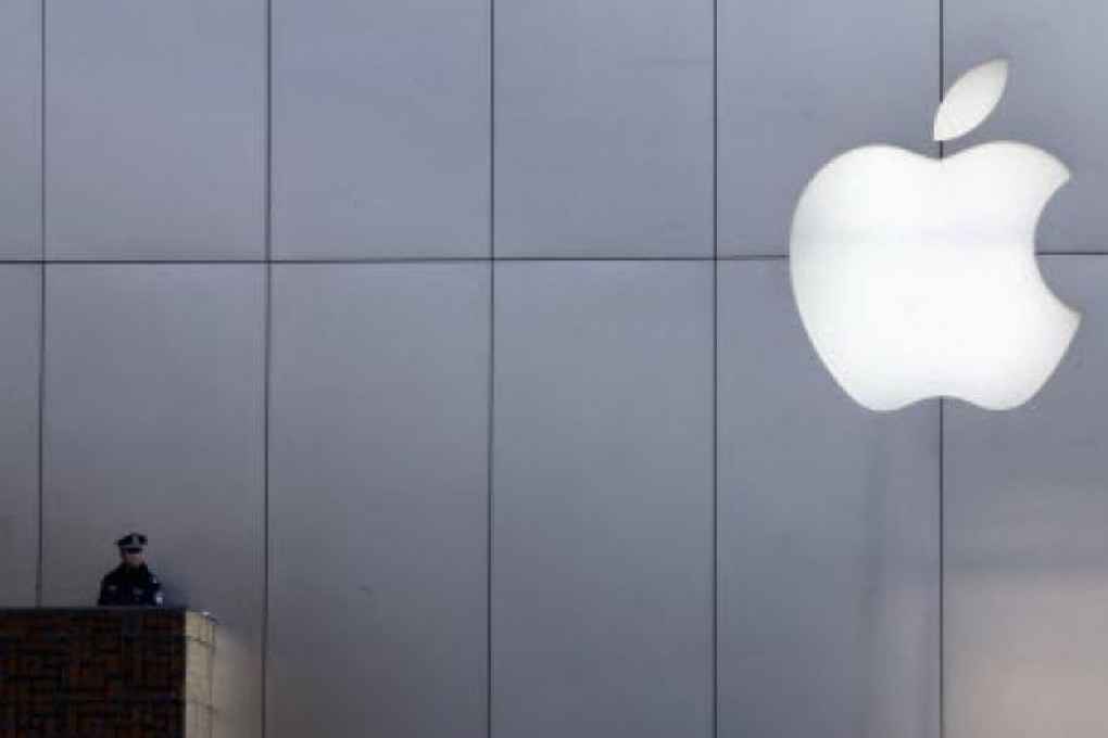 File photo of a policeman looking out from a balcony in front of an Apple store in Beijing. Reuters: David Gray