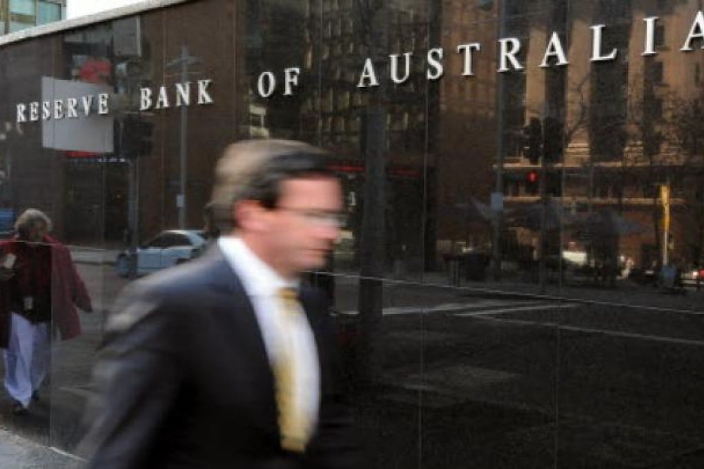 A businessman passes the Reserve Bank of Australia ( RBA) in Sydney. AFP: Torsten Blackwood