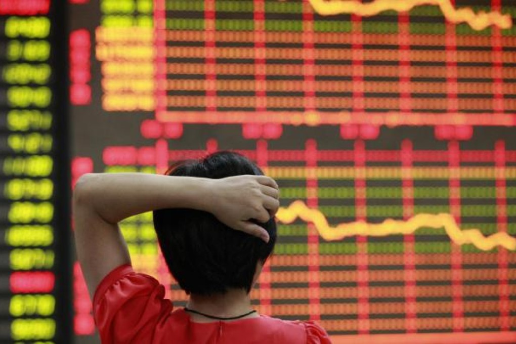 A dejected investor counts his losses at a brokerage house in Anhui as Shanghai stocks take another beating. Photo: Reuters