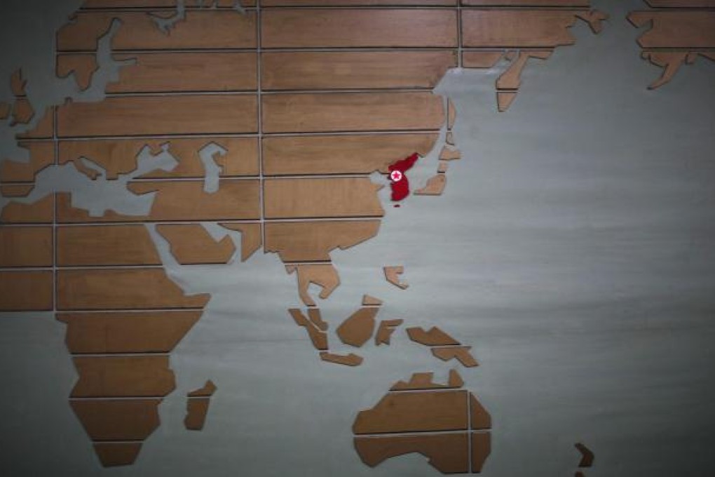 A world map, with the Korean peninsula in red, is fixed to the wall at a hotel reception in Rason City, northeast of Pyongyang. Photo: Reuters