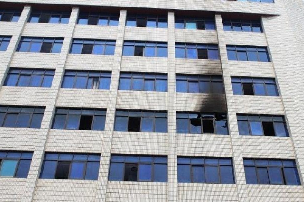 A smoke-blackened window is seen at an office building in Shaoyang city, Hunan, on Monday. Photo: SCMP Pictures