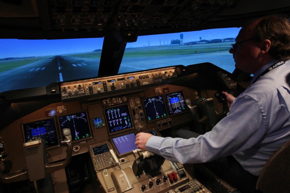 Simulator manager Chris O'Dea demonstrates the 747-8F cargo simulator at Cathay Pacific's training centre. Photo: Jonathan Wong