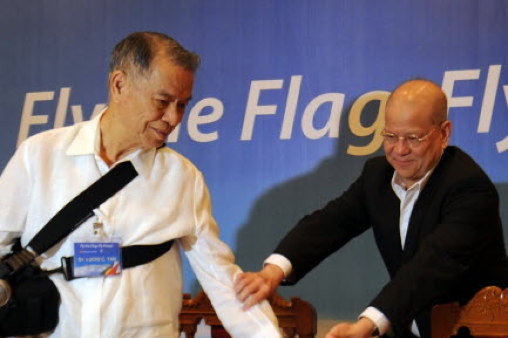 Philippine Airlines President Ramon Ang (R) and Lucio Tan (L), chairman of Philippine Airlines arrive for briefing on Airbus purchase in Manila  carrier. PHOTO: AFP/TED ALJIBE