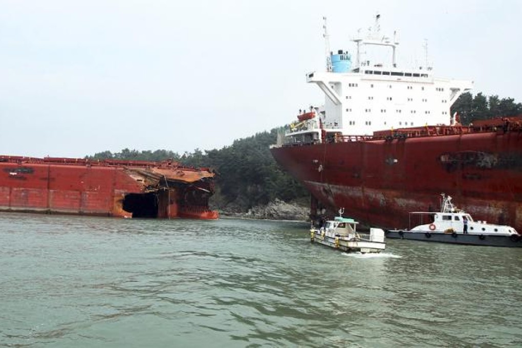 A cargo ship ran aground and snapped in two after Typhoon Bolaven hit Sacheon, South Korea, on Tuesday. Photo: AP