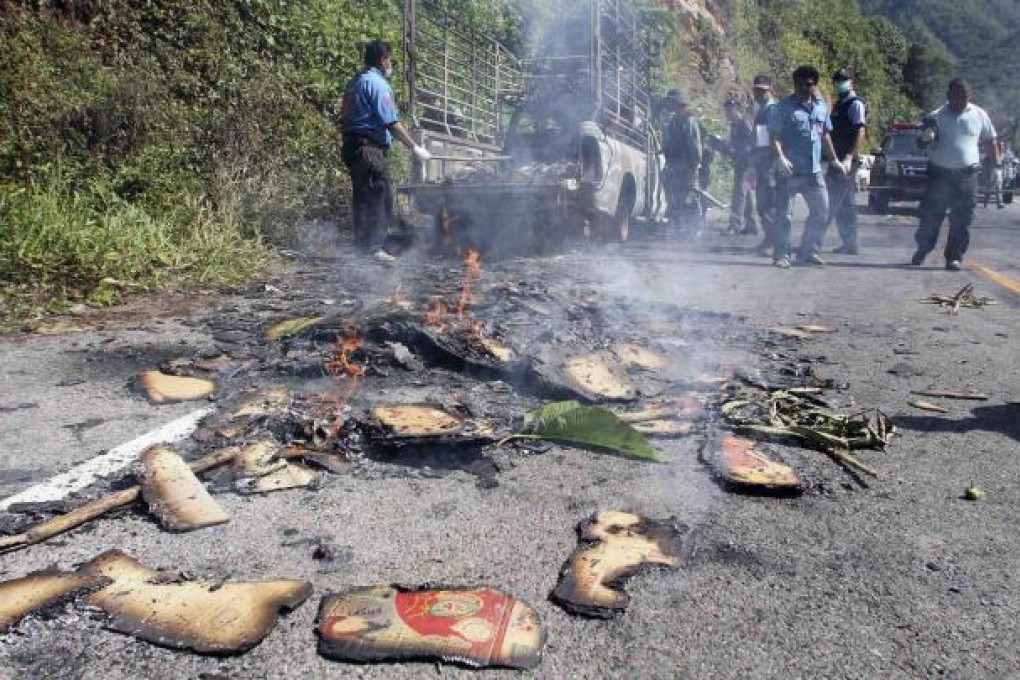 Police inspect the crime scene in Yala province. Photo: Reuters