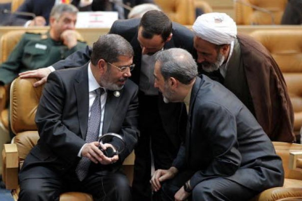 Egyptian President Muhammed Mursi talks with Iranian officials at the Non-Aligned Movement summit in Tehran. Photo: AP