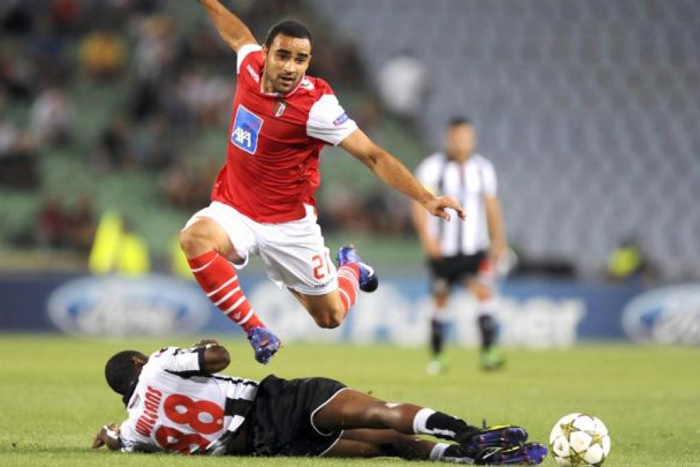 SC Braga’s Ismaily hurdles the fallen Williams of Udinese in the Champions League play-offs. SC Braga won a penalty shout-out. Photo: EPA