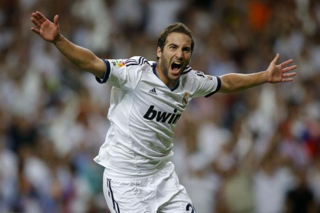 Real Madrid's Gonzalo Higuain celebrates after scoring a goal during the second leg of the Spanish Super Cup against FC Barcelona. Photo: AP