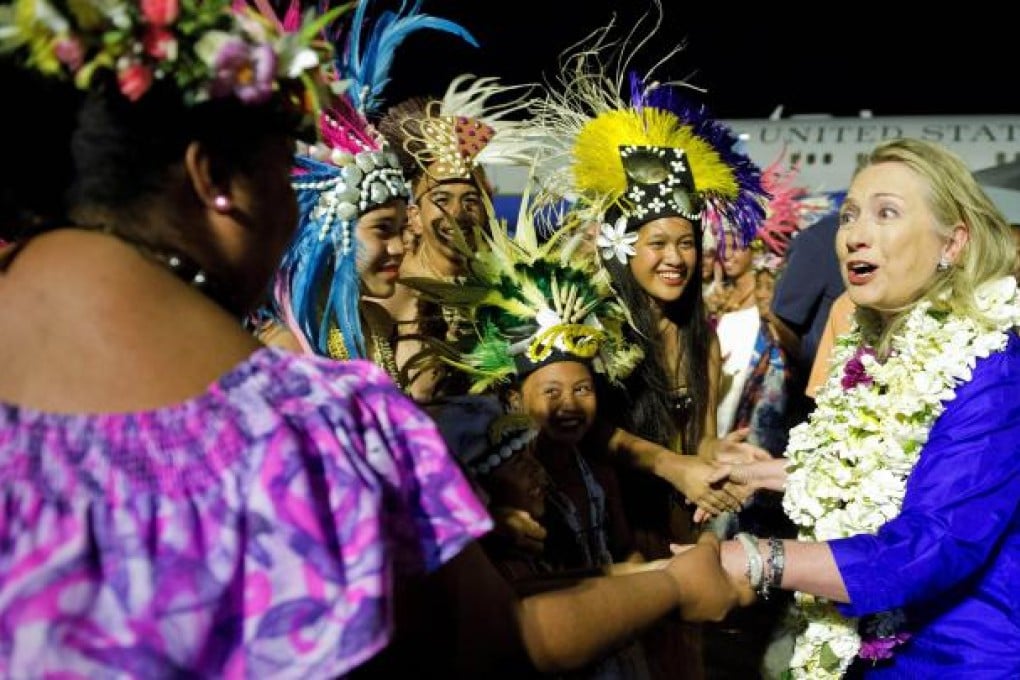 US Secretary of State Hillary Rodham Clinton, right, is greeted upon her arrival at Rarotonga International Airport. Photo: AP