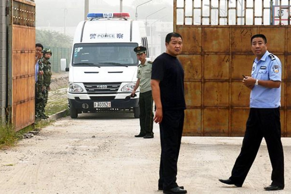 Police wait outside the Beijing No 2 prison after the release of dissident Wang Xiaoning on Friday. Photo: AFP